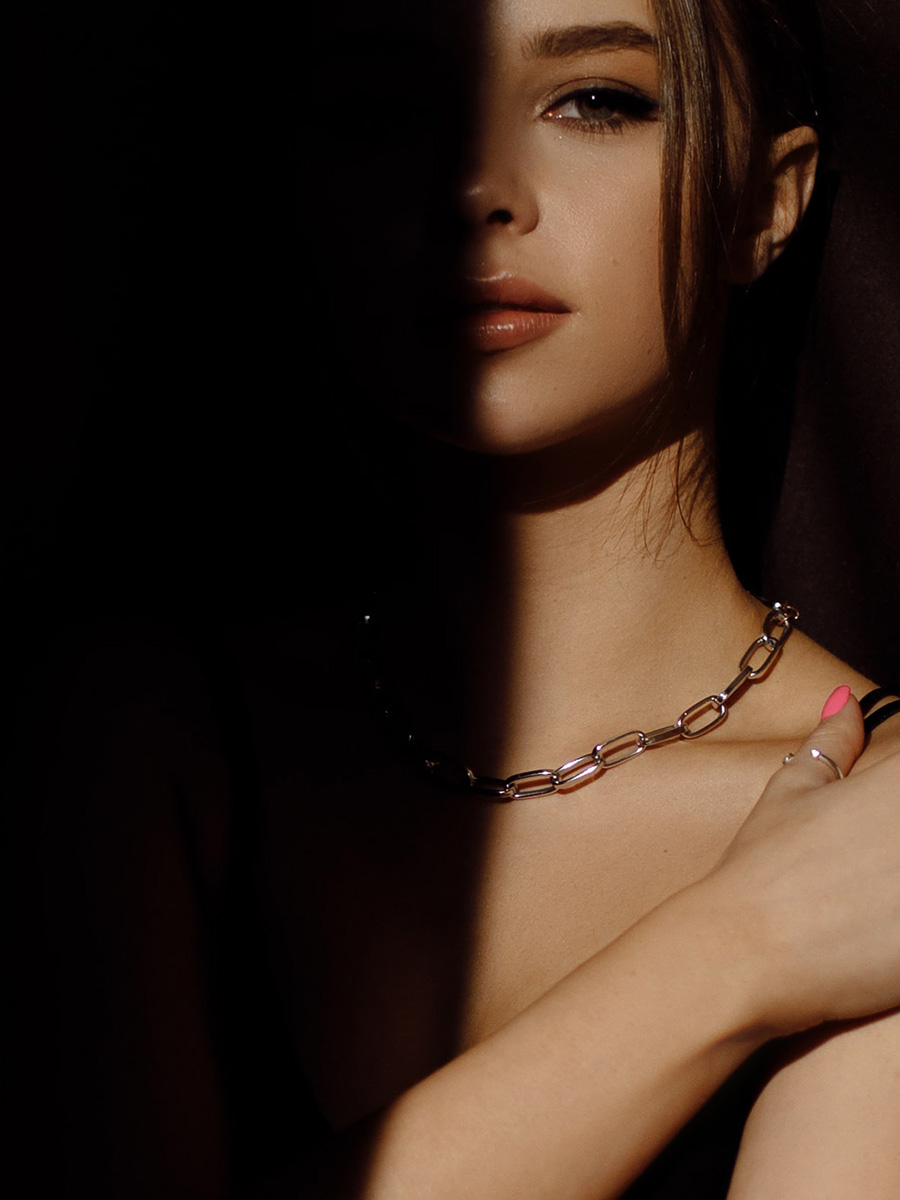 Woman with half her face cast in shadow